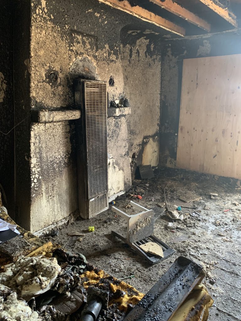 Smoke-damaged room with fireplace