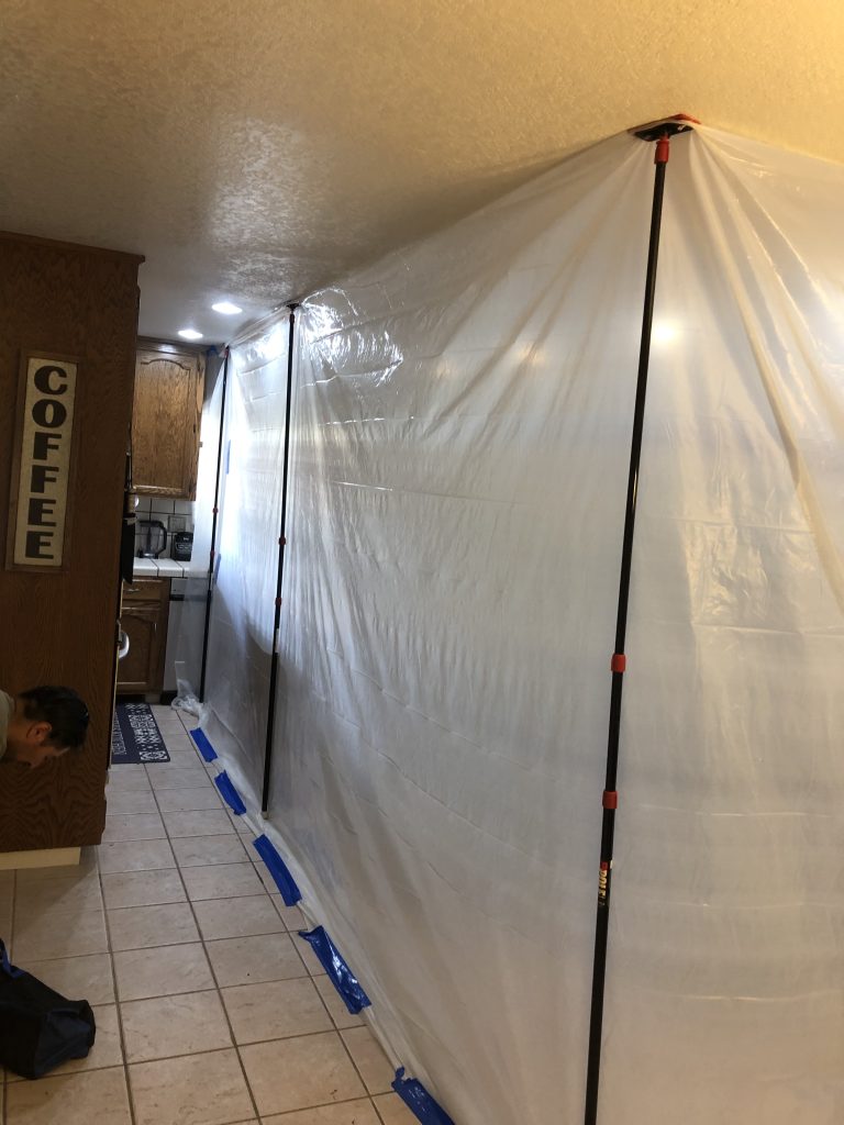 white tarp covering the wall